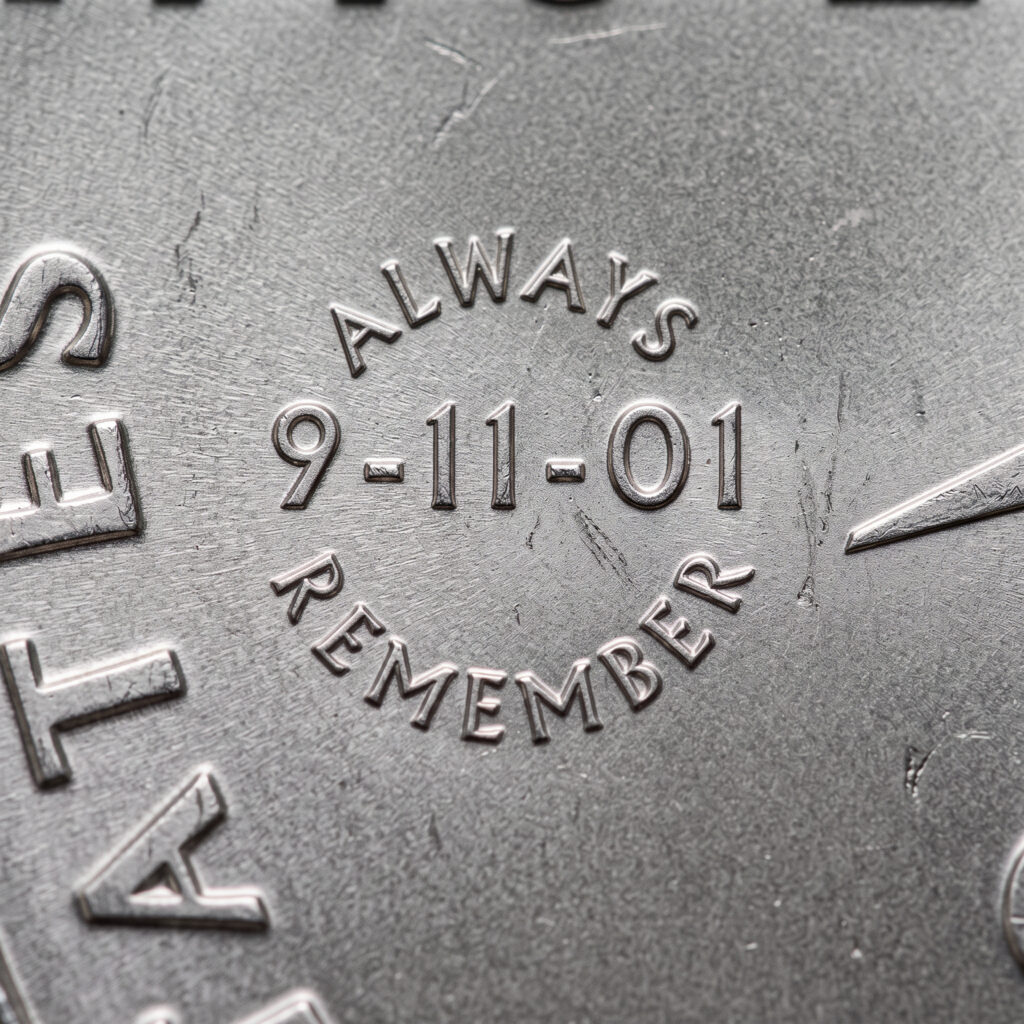 Close-up of the 9-11-01 privy mark encircled by ALWAYS REMEMBER on the West Point Enduring Liberty half dollar