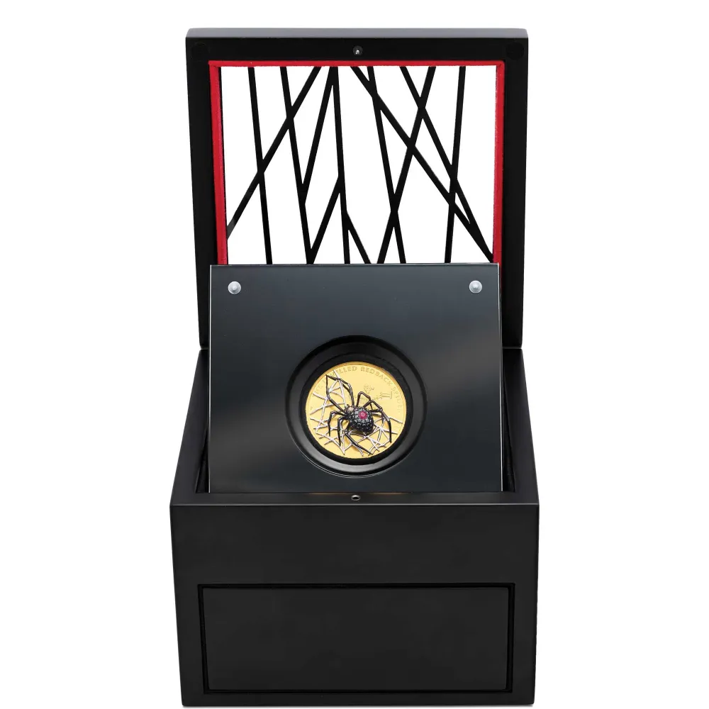 Jewelled Redback Spider presentation case, black box with glass lid and web overlay, open to show the coin on its upright shelf and red lined outer case